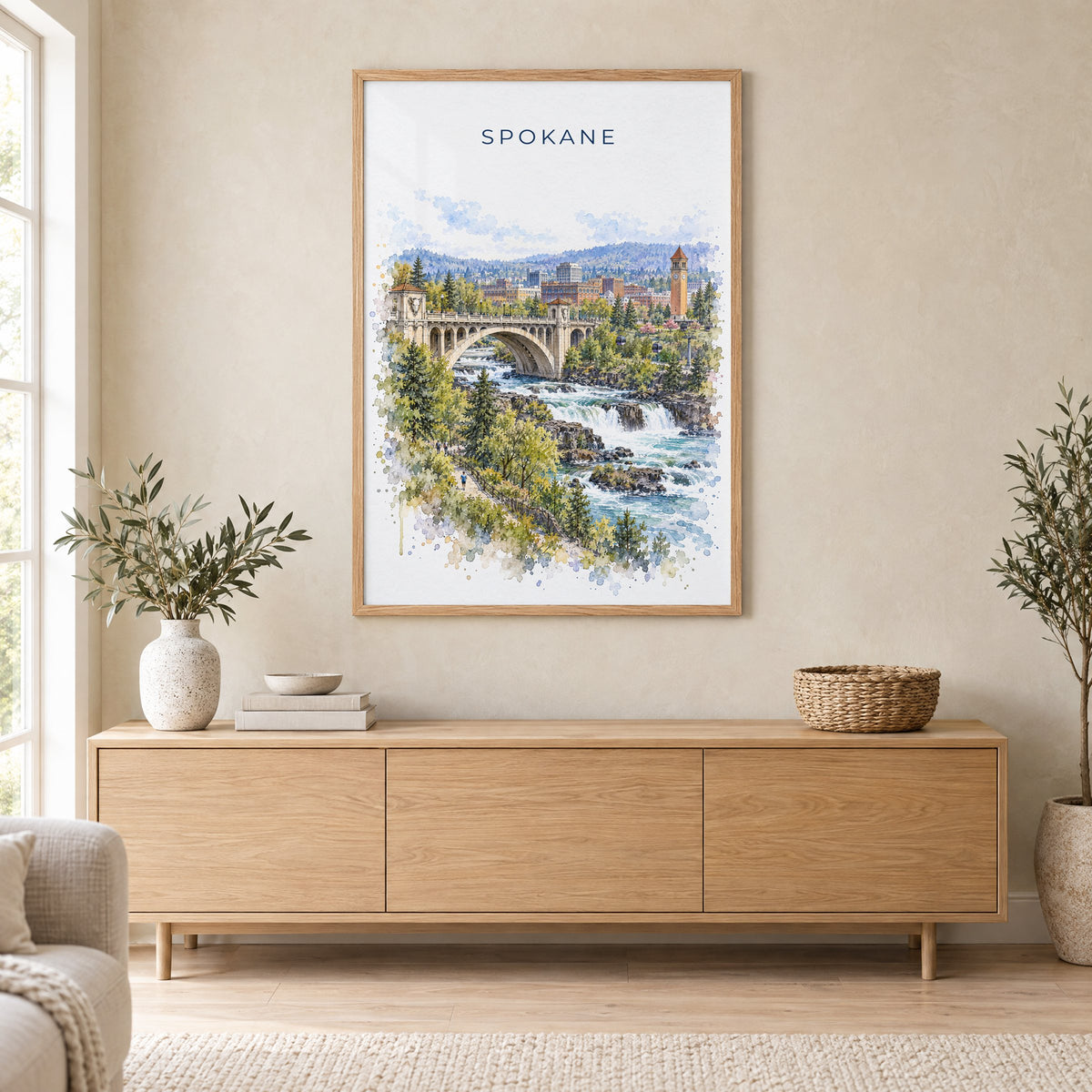 Spokane watercolor print in an oak frame above a light wood sideboard in a Scandinavian living room