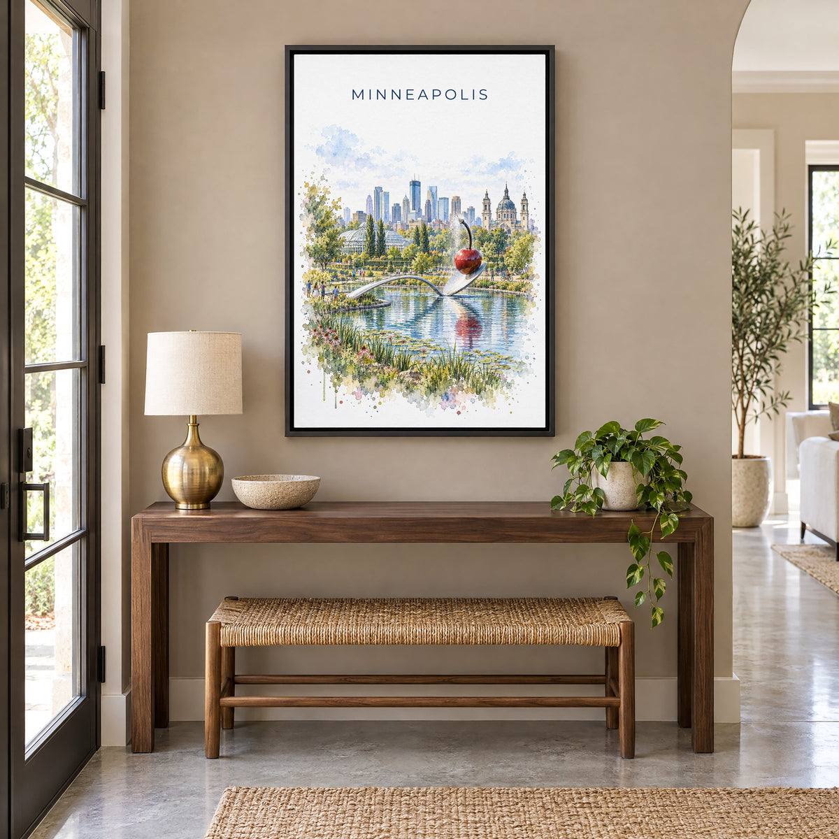 Spoonbridge and Cherry watercolor print as a black floater canvas above a walnut console and woven bench in an entryway