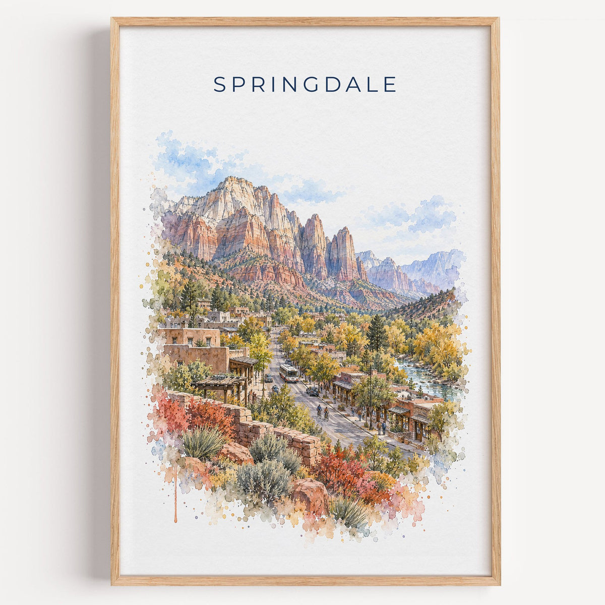 Springdale, Utah watercolor print in a light oak frame on a plain white wall