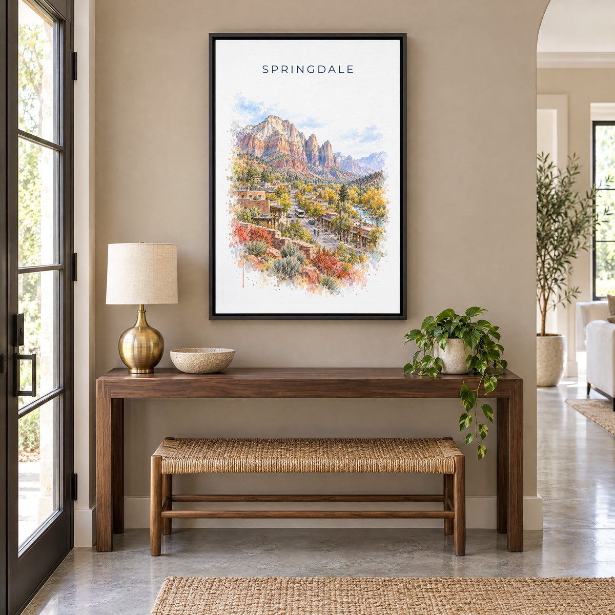 Springdale, Utah watercolor print as a black floater canvas above a walnut console and woven bench in an entryway