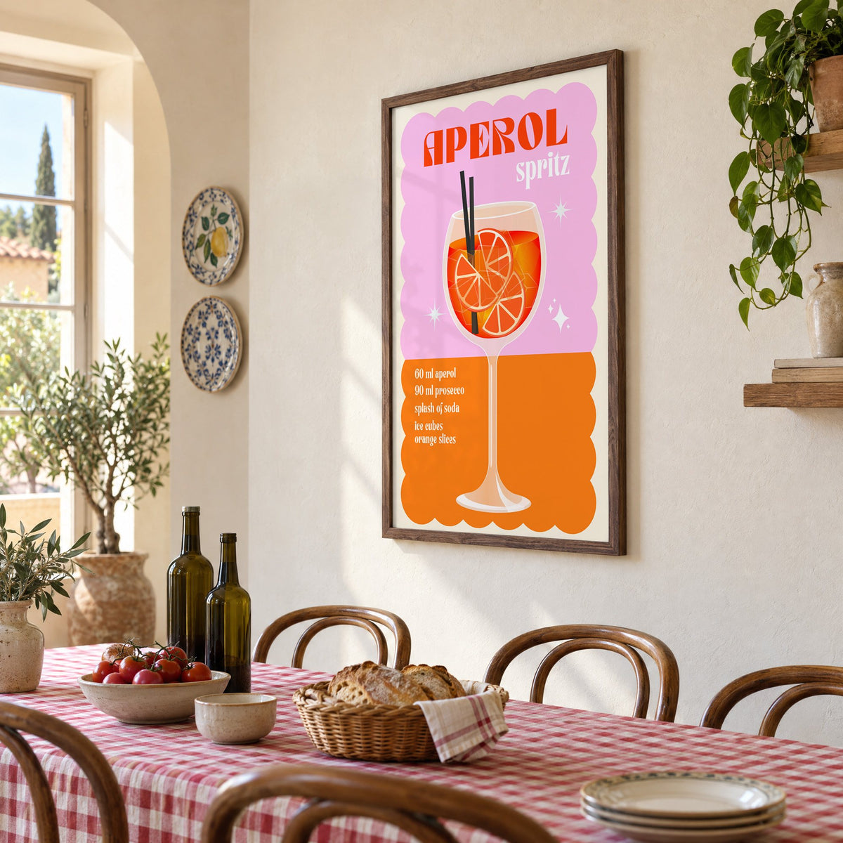 Spritz recipe pink and orange print in a walnut frame above a gingham-covered trattoria table, seen at an angle
