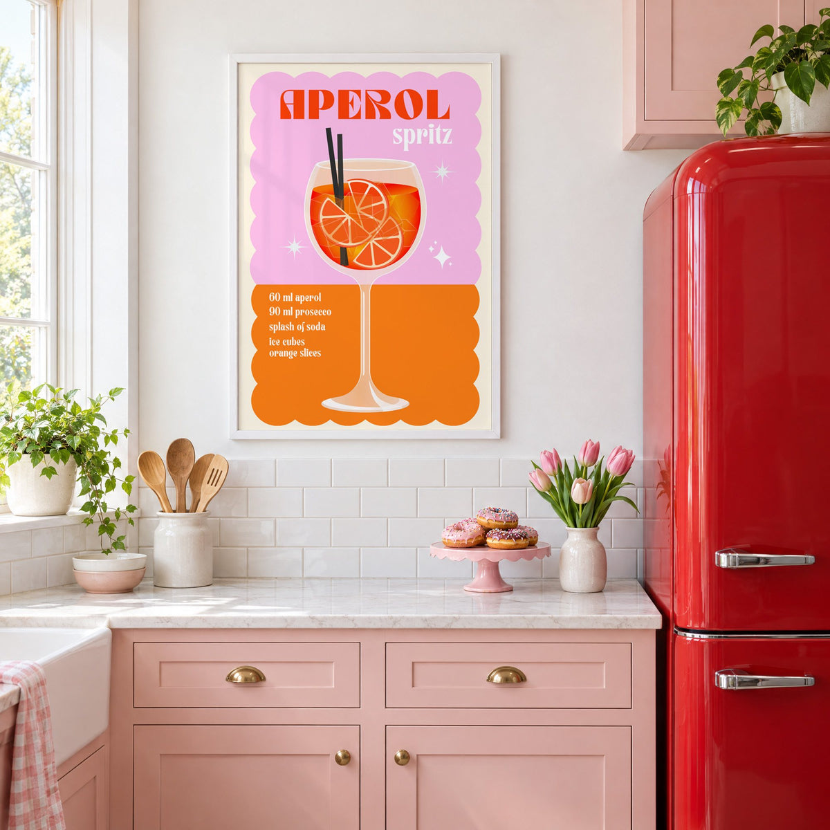 Spritz recipe pink and orange print in a white frame in a pink kitchen beside a red retro fridge