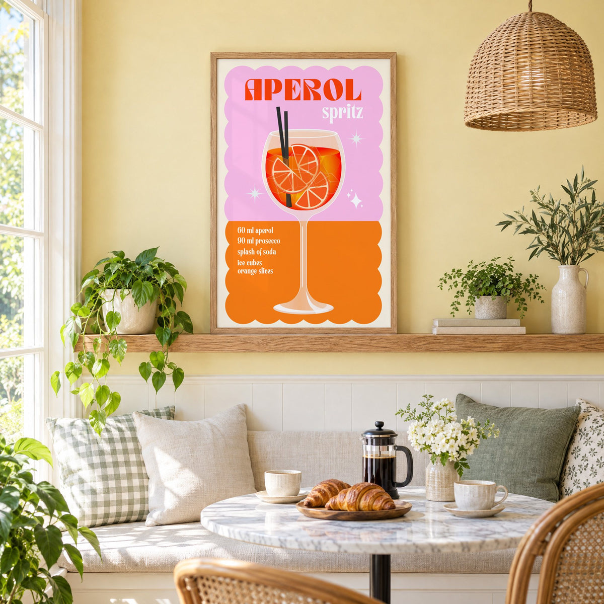 Spritz recipe pink and orange print in an oak frame on a picture ledge above a sunny breakfast nook