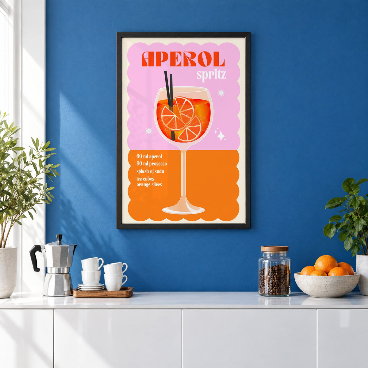 Spritz recipe pink and orange print in a black frame on a cobalt blue wall above a coffee station
