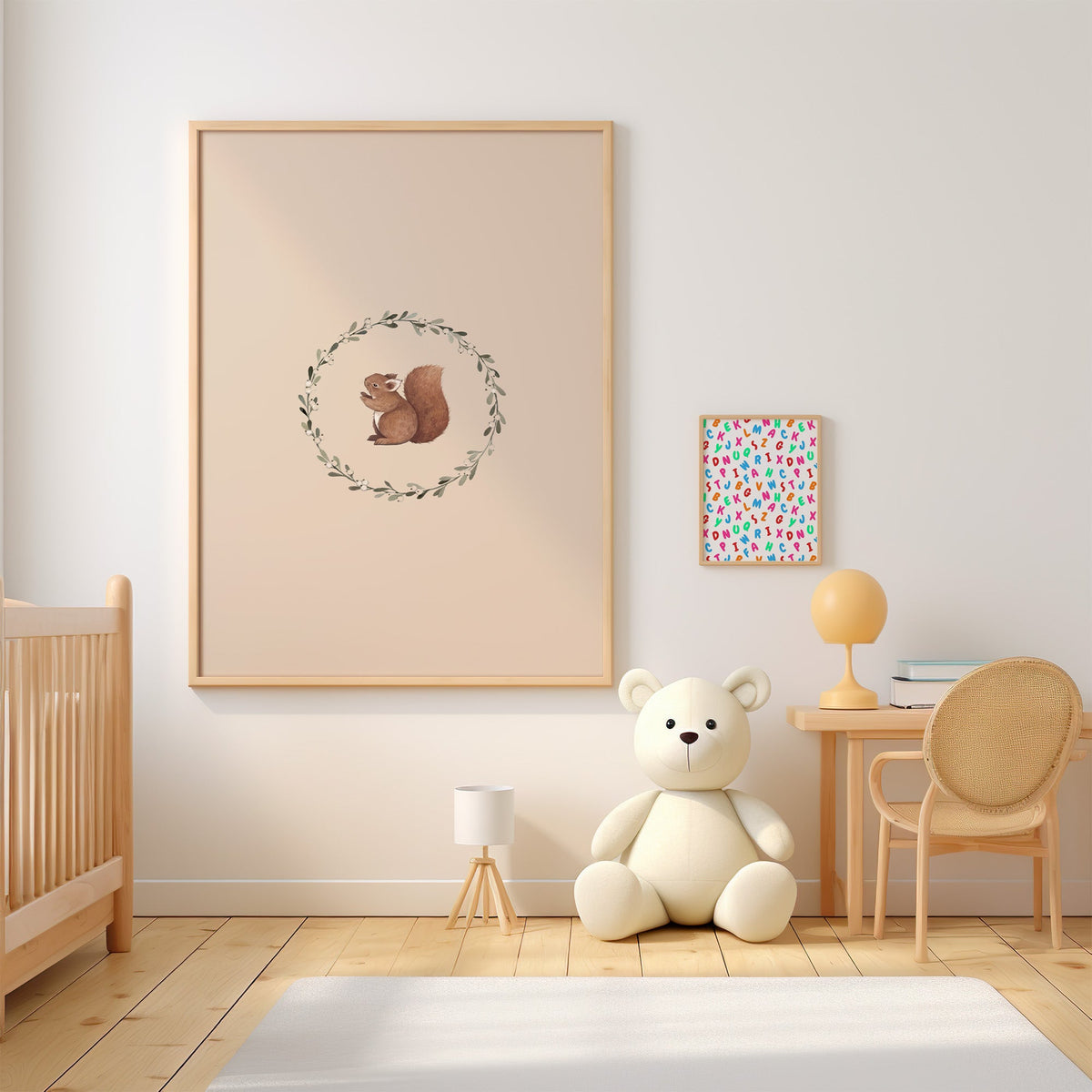 Squirrel inside a mistletoe wreath nursery print in an oak frame above a wooden crib beside a cream teddy bear