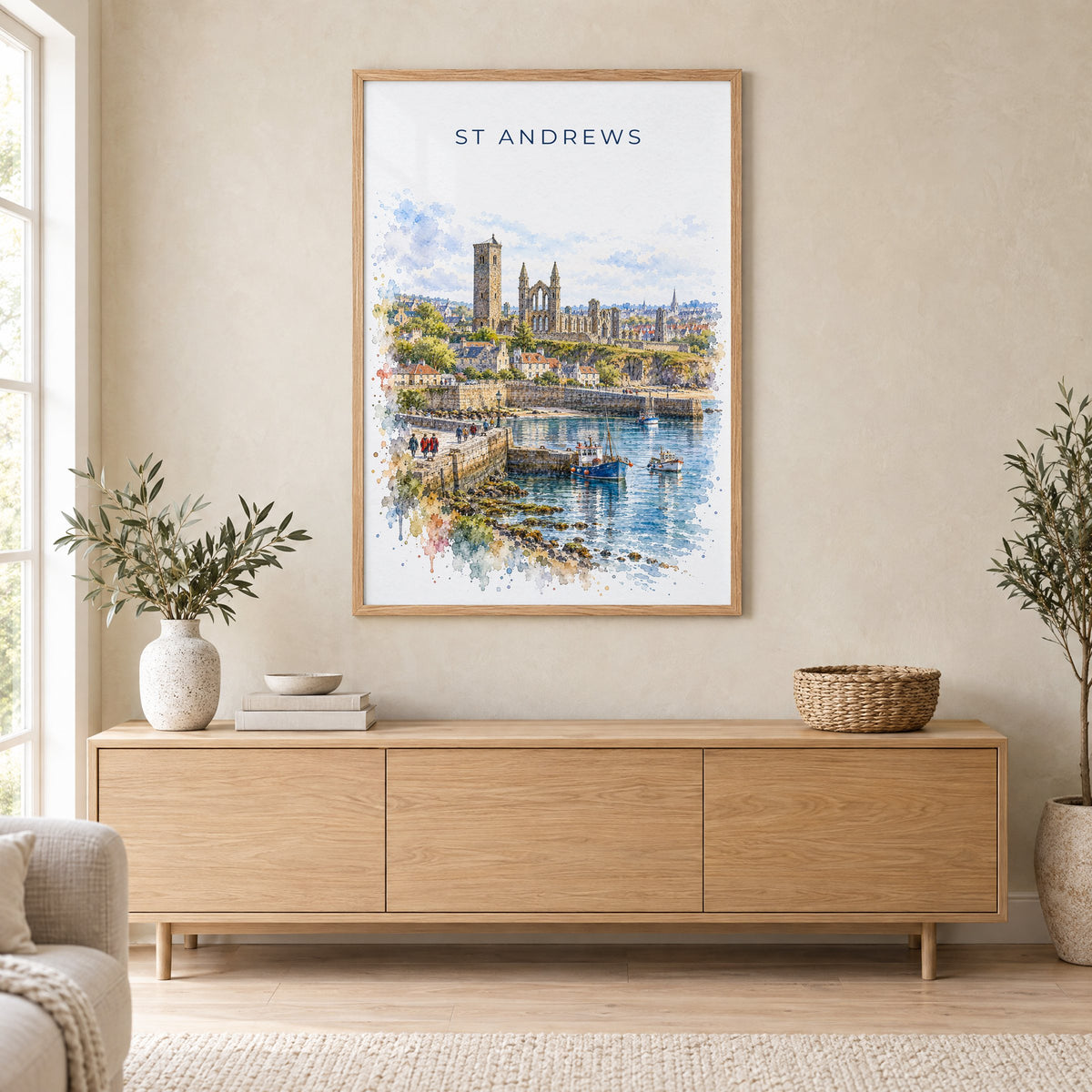 St Andrews watercolor print in an oak frame above a light wood sideboard in a Scandinavian living room