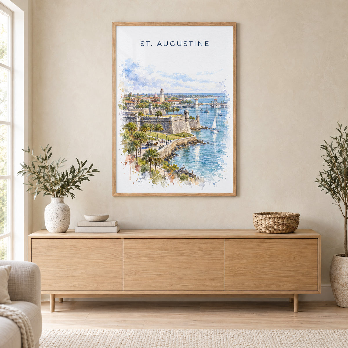 St. Augustine watercolor print in an oak frame above a light wood sideboard in a Scandinavian living room