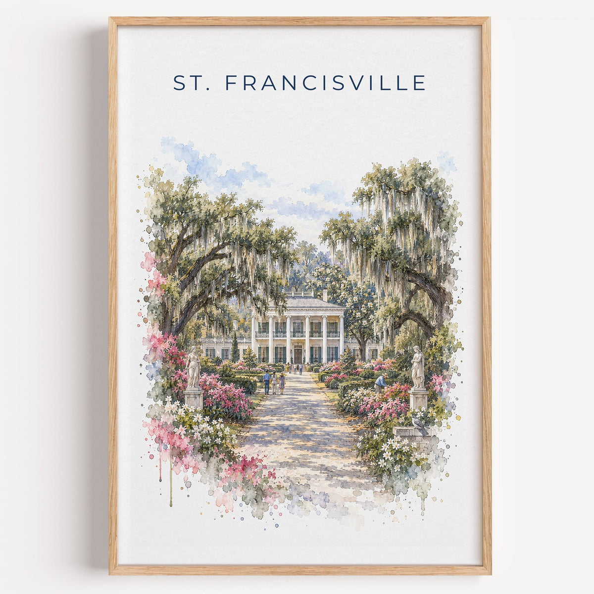 St. Francisville, Louisiana watercolor print in a light oak frame on a plain white wall