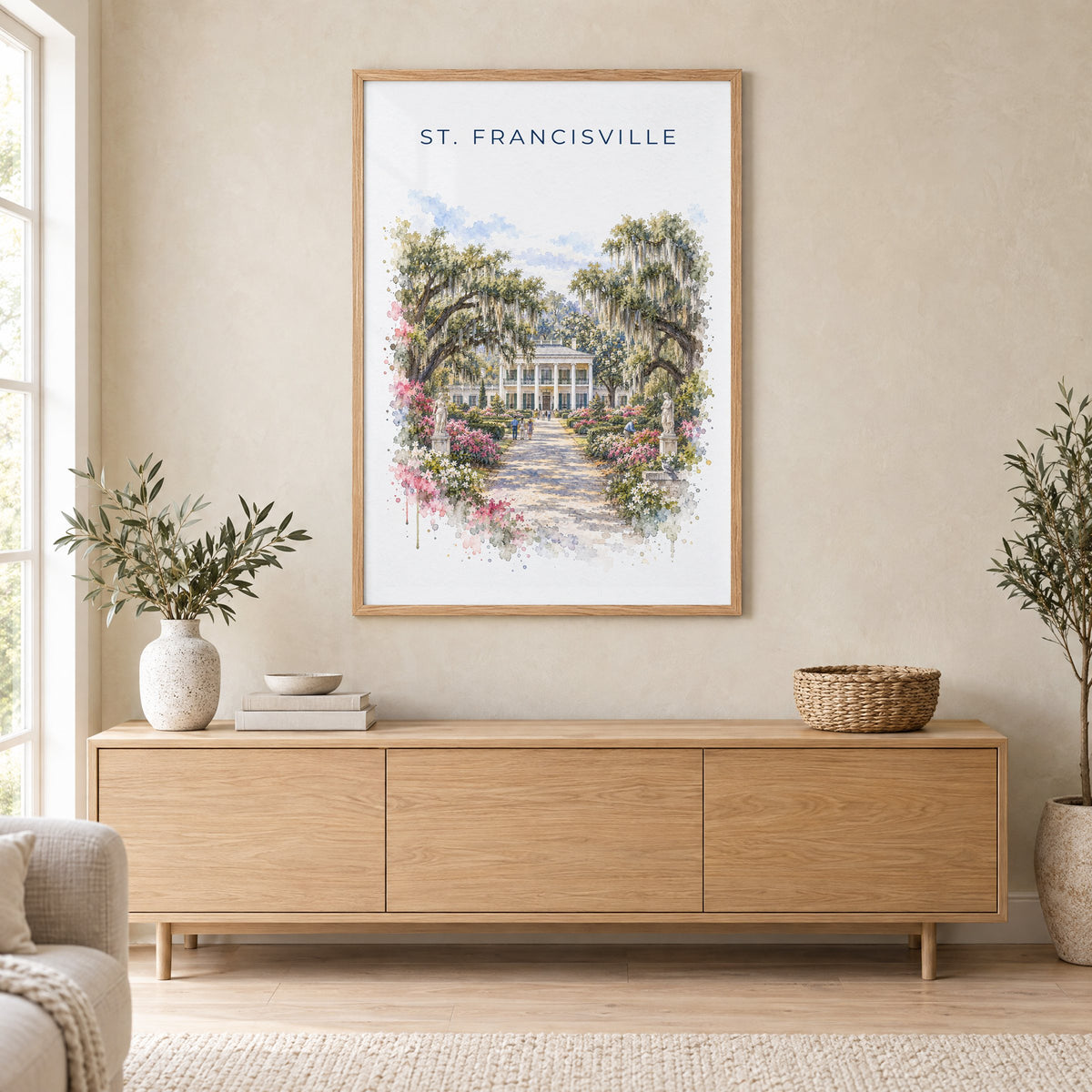 St. Francisville, Louisiana watercolor print in an oak frame above a light wood sideboard in a Scandinavian living room