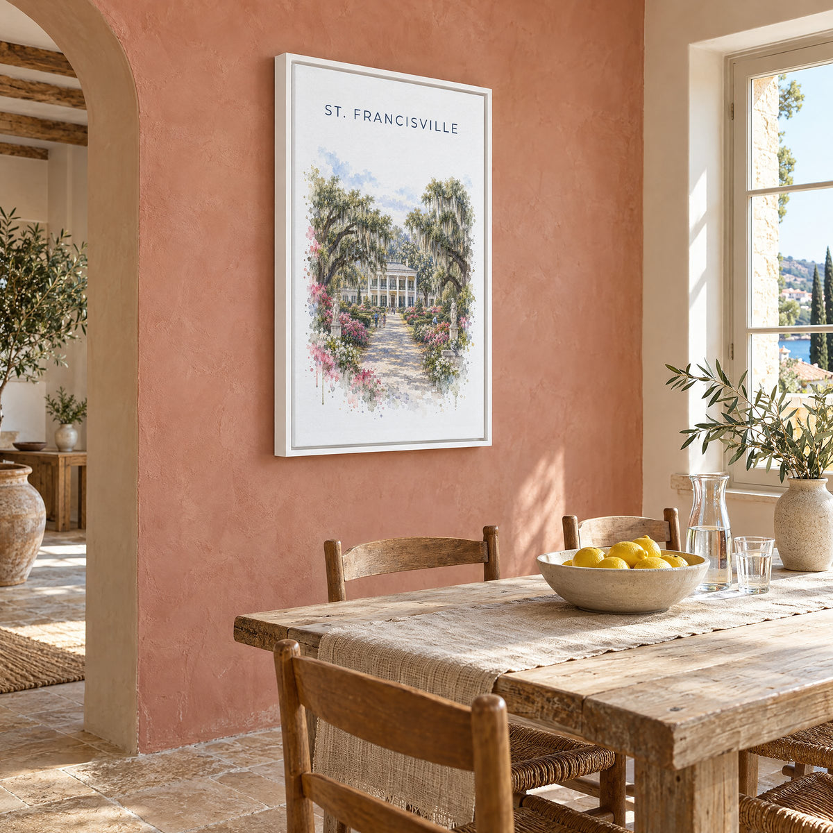 St. Francisville, Louisiana watercolor print as a white floater canvas on a terracotta wall above a rustic dining table