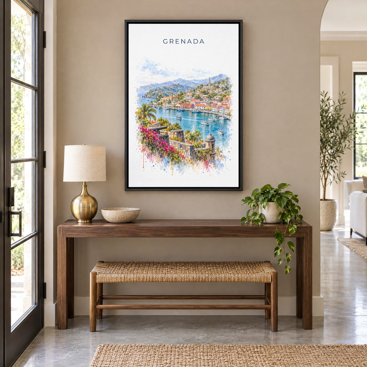 Grenada watercolor print as a black floater canvas above a walnut console and woven bench in an entryway