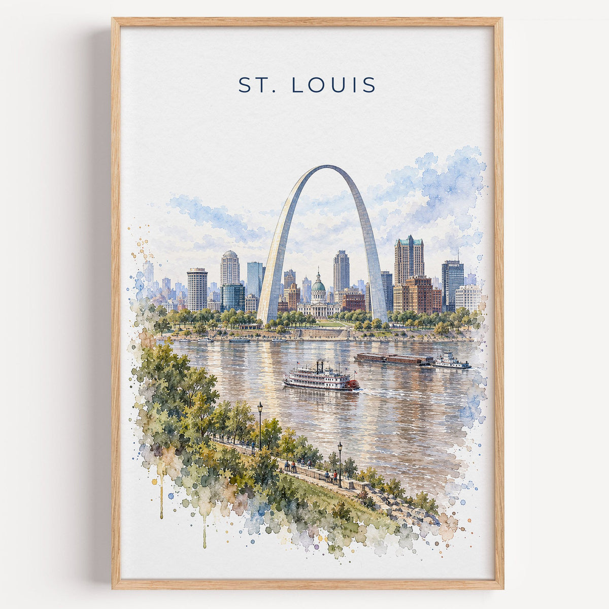 St. Louis watercolor print in a light oak frame on a plain white wall