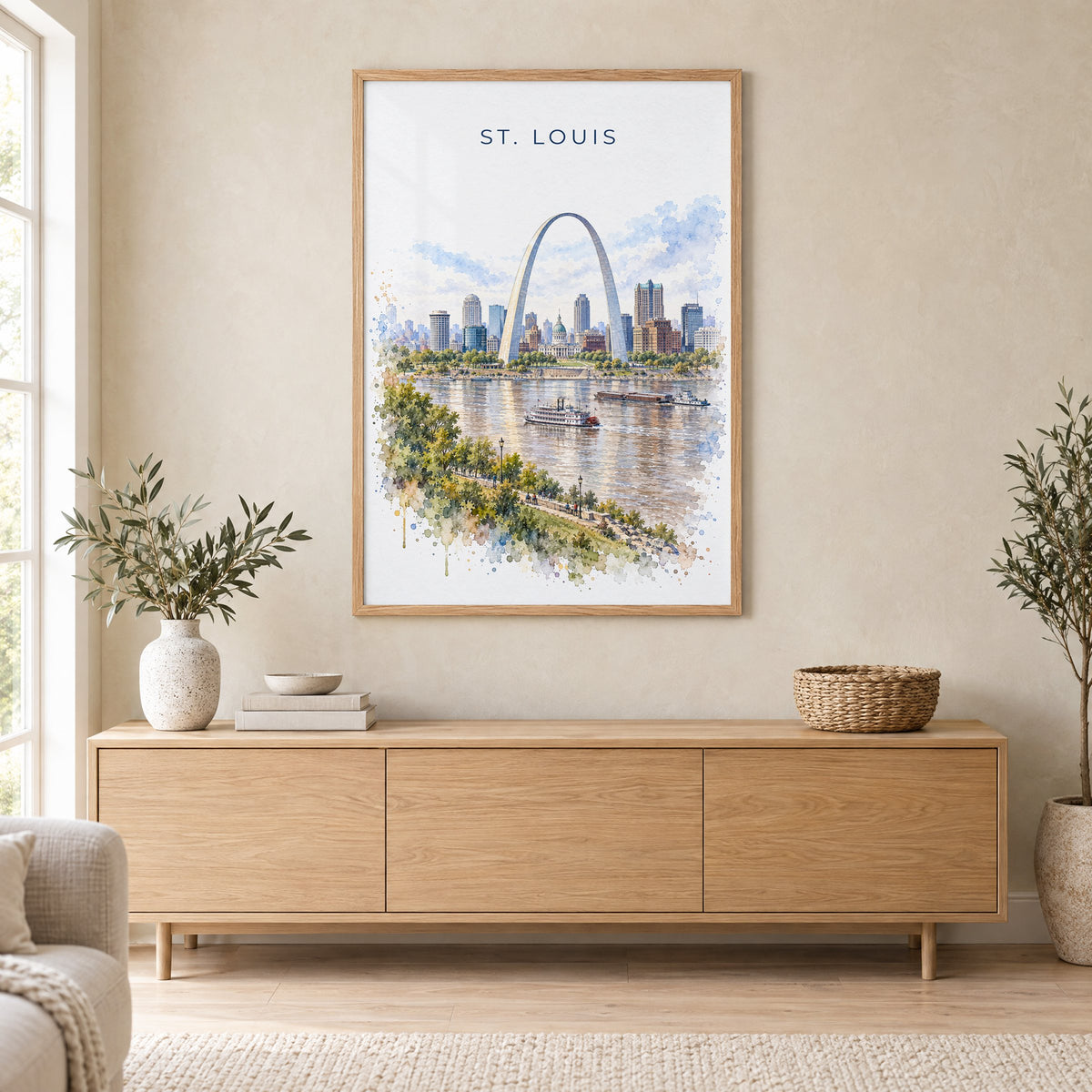 St. Louis watercolor print in an oak frame above a light wood sideboard in a Scandinavian living room