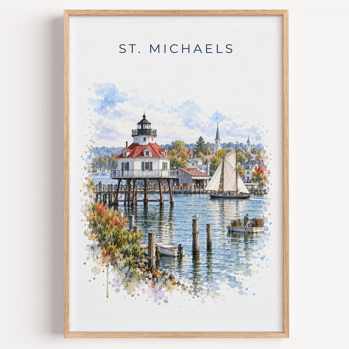 St. Michaels, Maryland watercolor print in a light oak frame on a plain white wall
