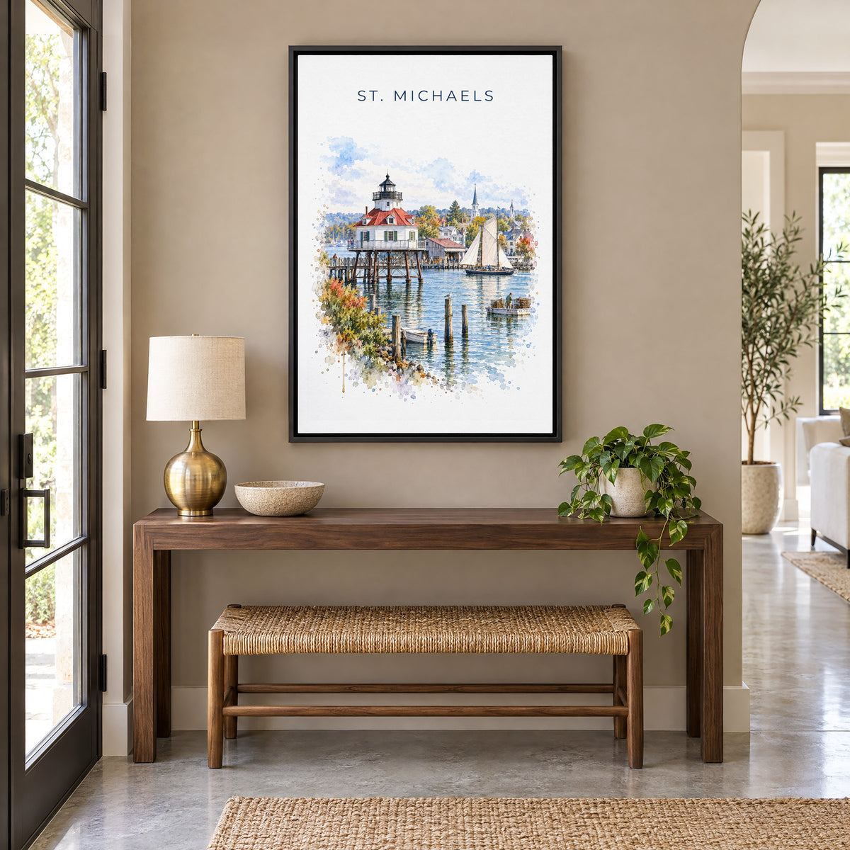 St. Michaels, Maryland watercolor print as a black floater canvas above a walnut console and woven bench in an entryway