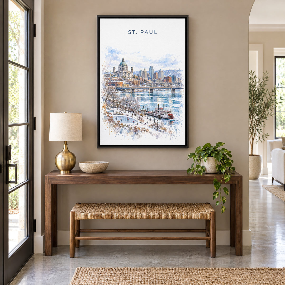 St. Paul watercolor print as a black floater canvas above a walnut console and woven bench in an entryway