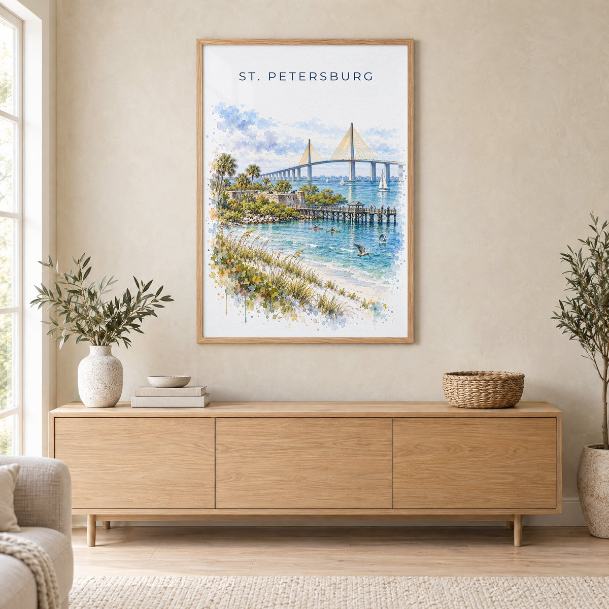 St. Petersburg, Florida watercolor print in an oak frame above a light wood sideboard in a Scandinavian living room