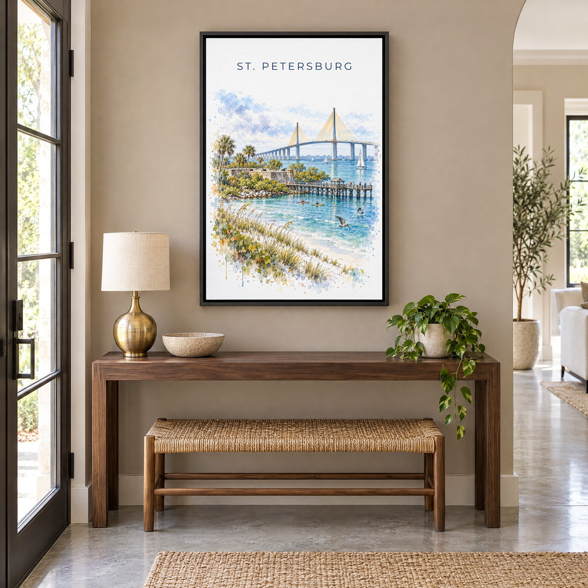 St. Petersburg, Florida watercolor print as a black floater canvas above a walnut console and woven bench in an entryway