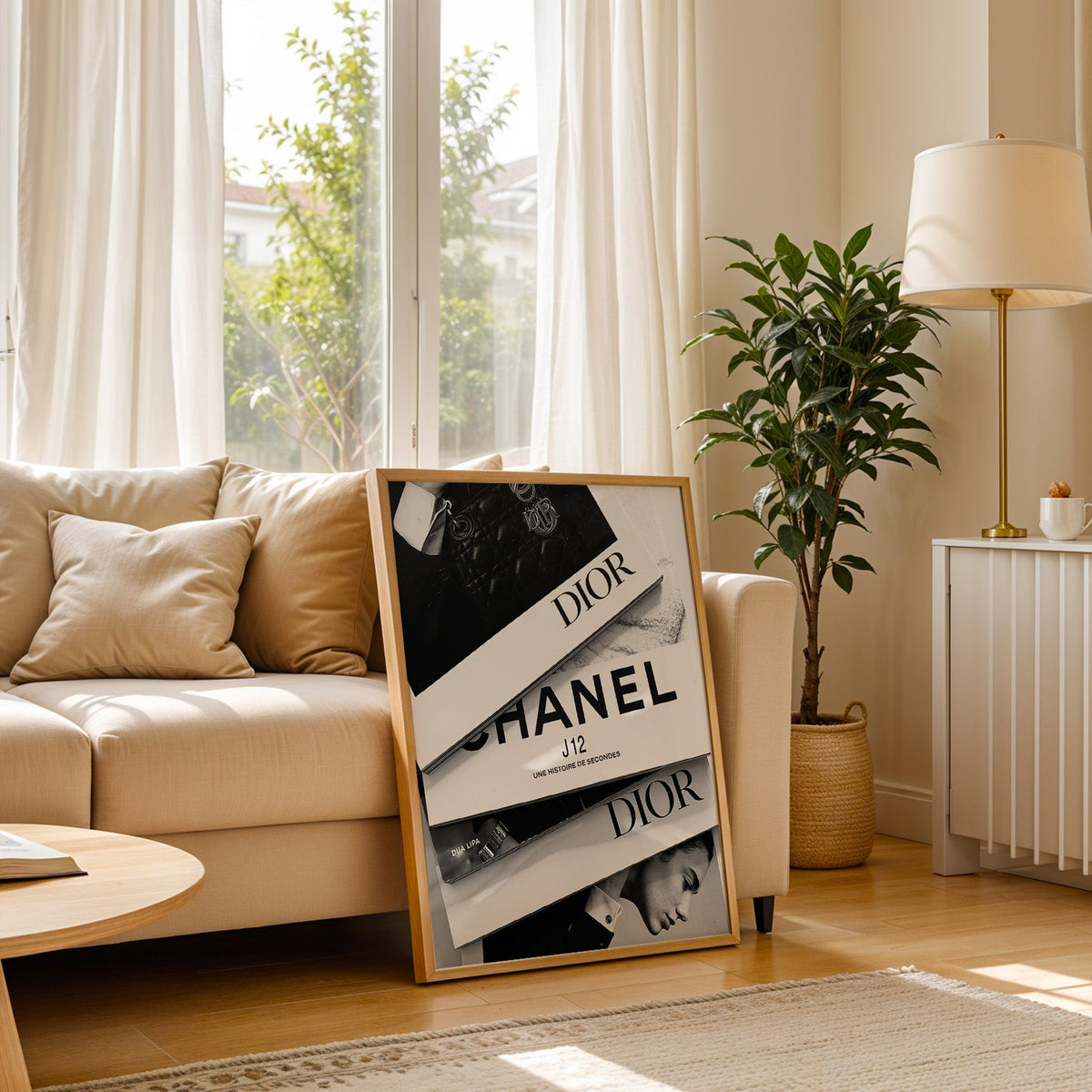 Top-down flat lay of four fashion books print in a light oak frame leaning on a cream sofa beside a floor lamp