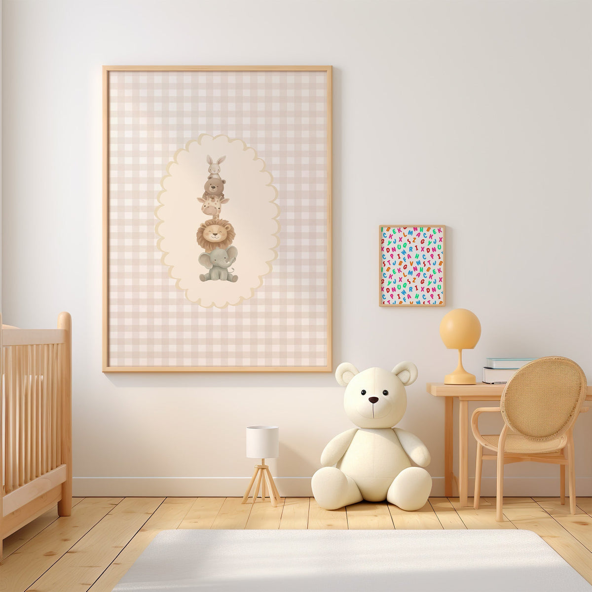 Stacked baby animals in oval on gingham nursery print in an oak frame above a wooden crib beside a cream teddy bear
