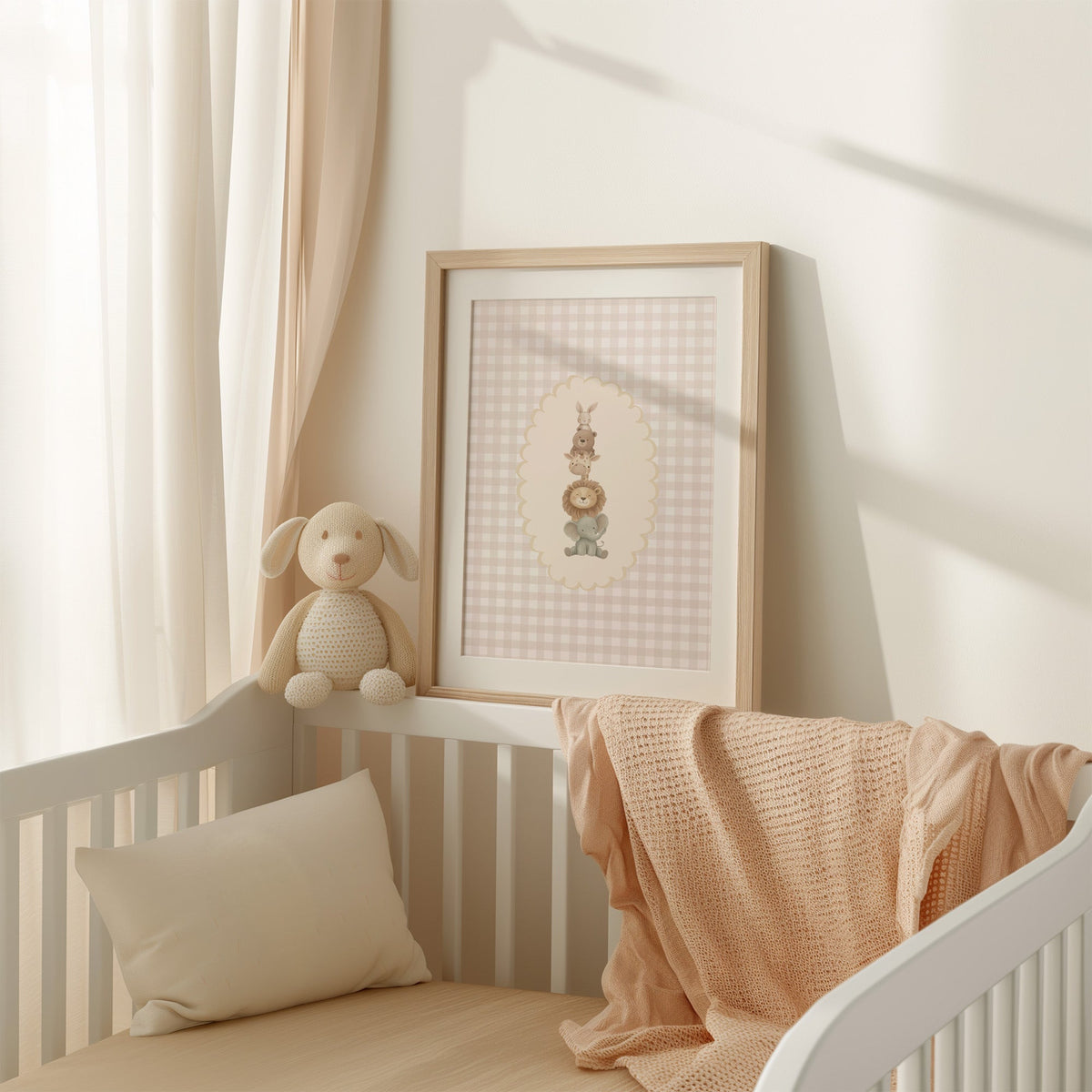 Stacked baby animals in oval on gingham nursery print shown in an oak frame with a white mat on a crib rail
