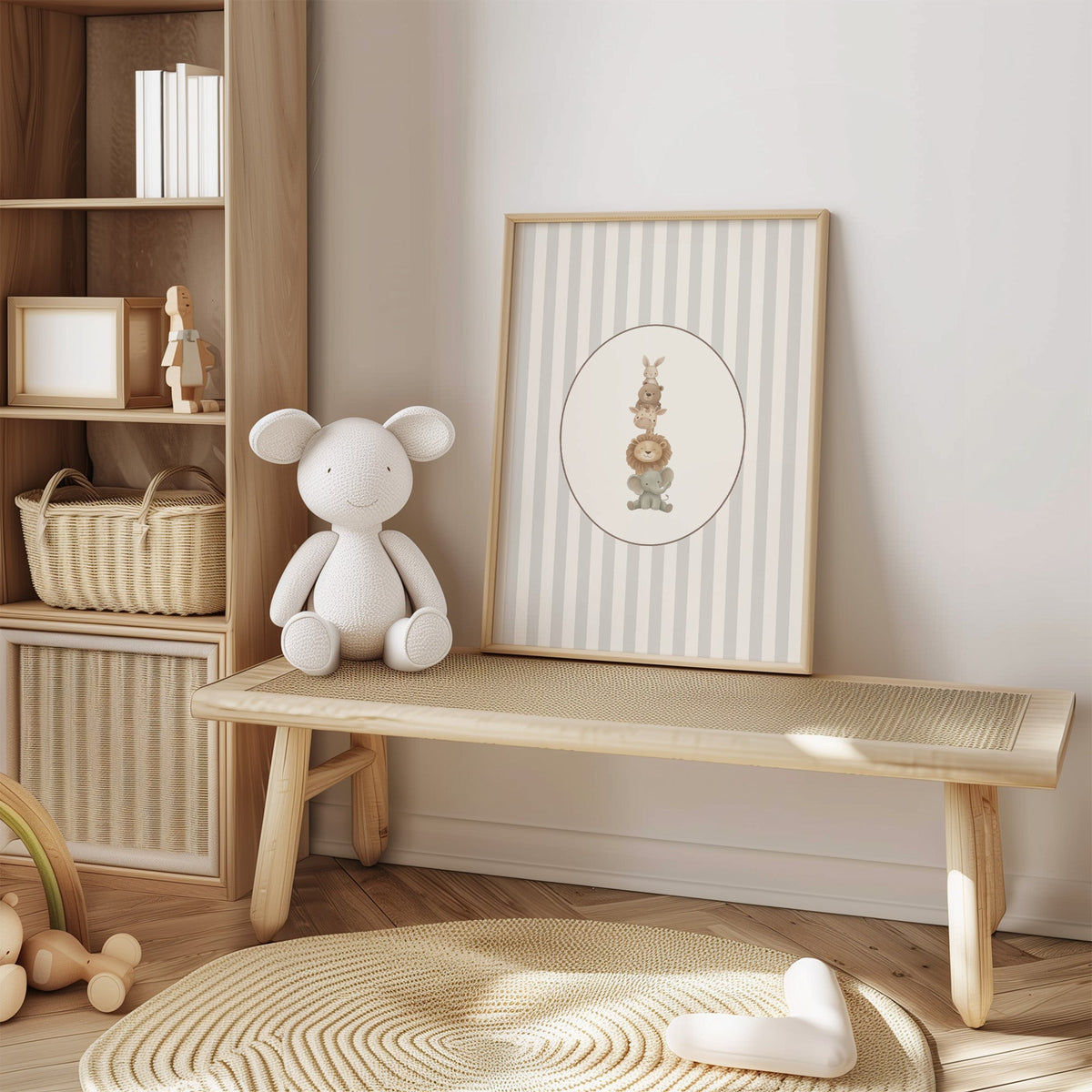 Stacked safari animals on grey stripes nursery print in an oak frame on a cane bench beside a white knit plush