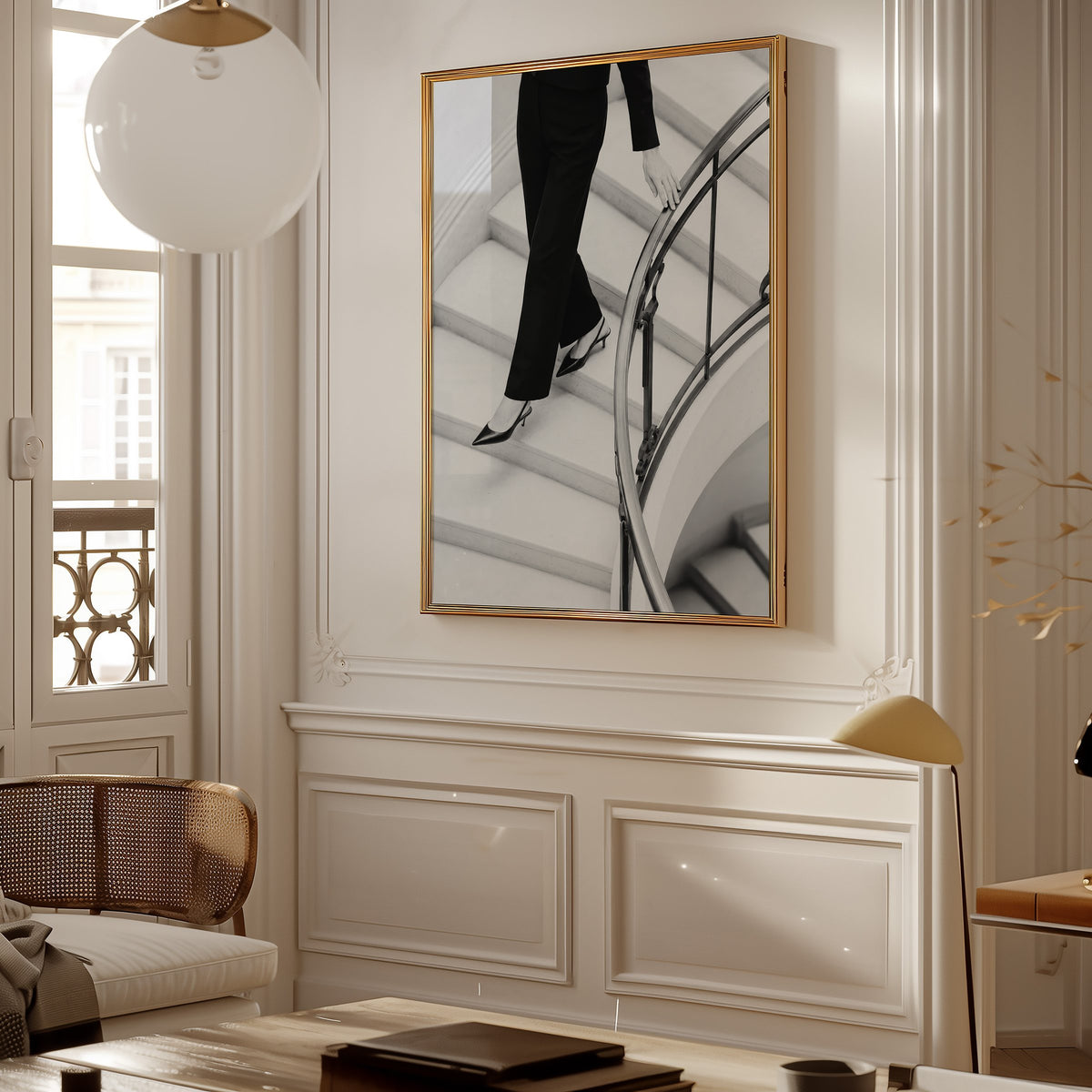 Black trousers and slingback heels on curved stairs print shown in a gold frame in a Parisian paneled living room