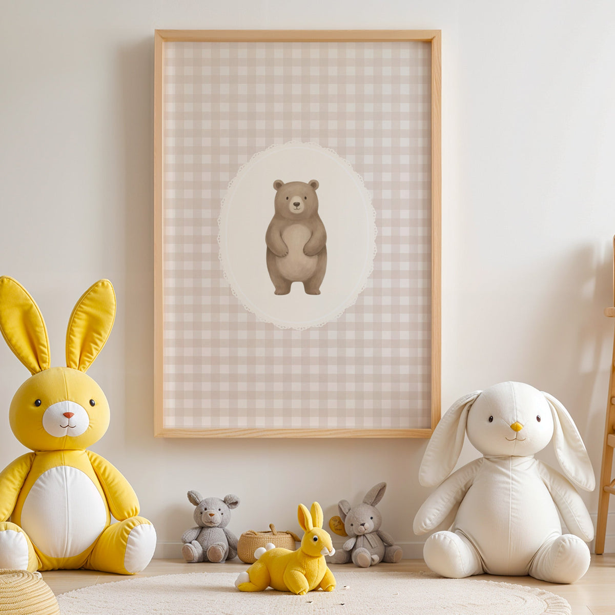 Standing bear in a lace oval on beige gingham nursery print in an oak frame above yellow and white plush bunnies