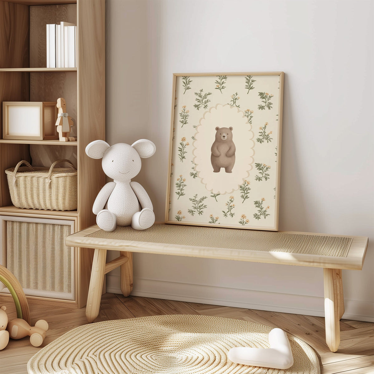 Standing bear on wildflower wallpaper nursery print in an oak frame on a cane bench beside a white knit plush