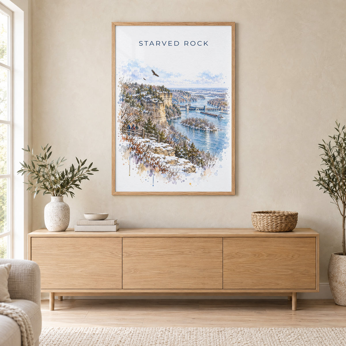 Starved Rock watercolor print in an oak frame above a light wood sideboard in a Scandinavian living room