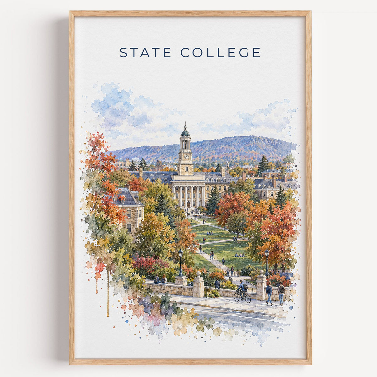 State College watercolor print in a light oak frame on a plain white wall