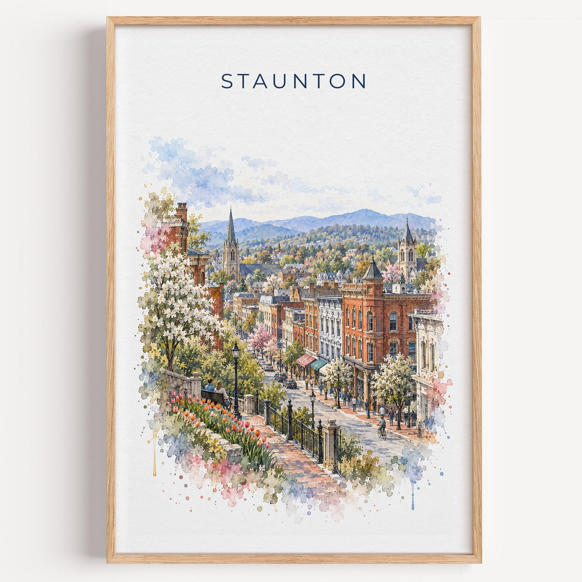 Staunton, Virginia watercolor print in a light oak frame on a plain white wall