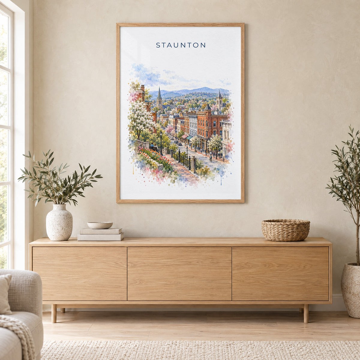 Staunton, Virginia watercolor print in an oak frame above a light wood sideboard in a Scandinavian living room