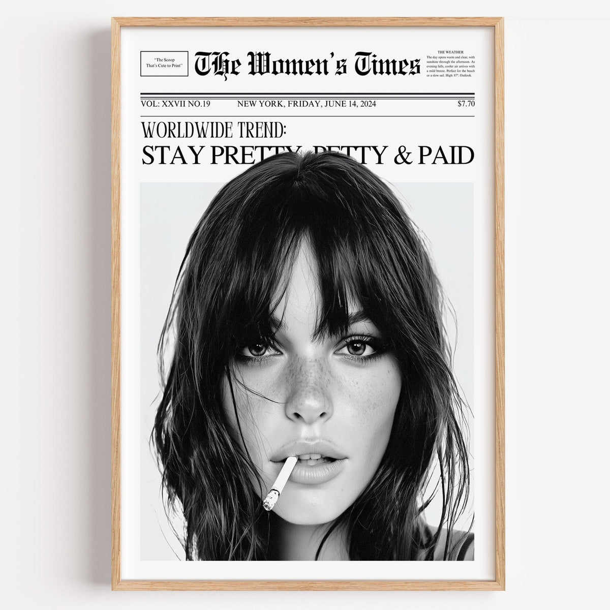 Freckled close-up portrait mock front page print in a light oak frame on a plain white wall