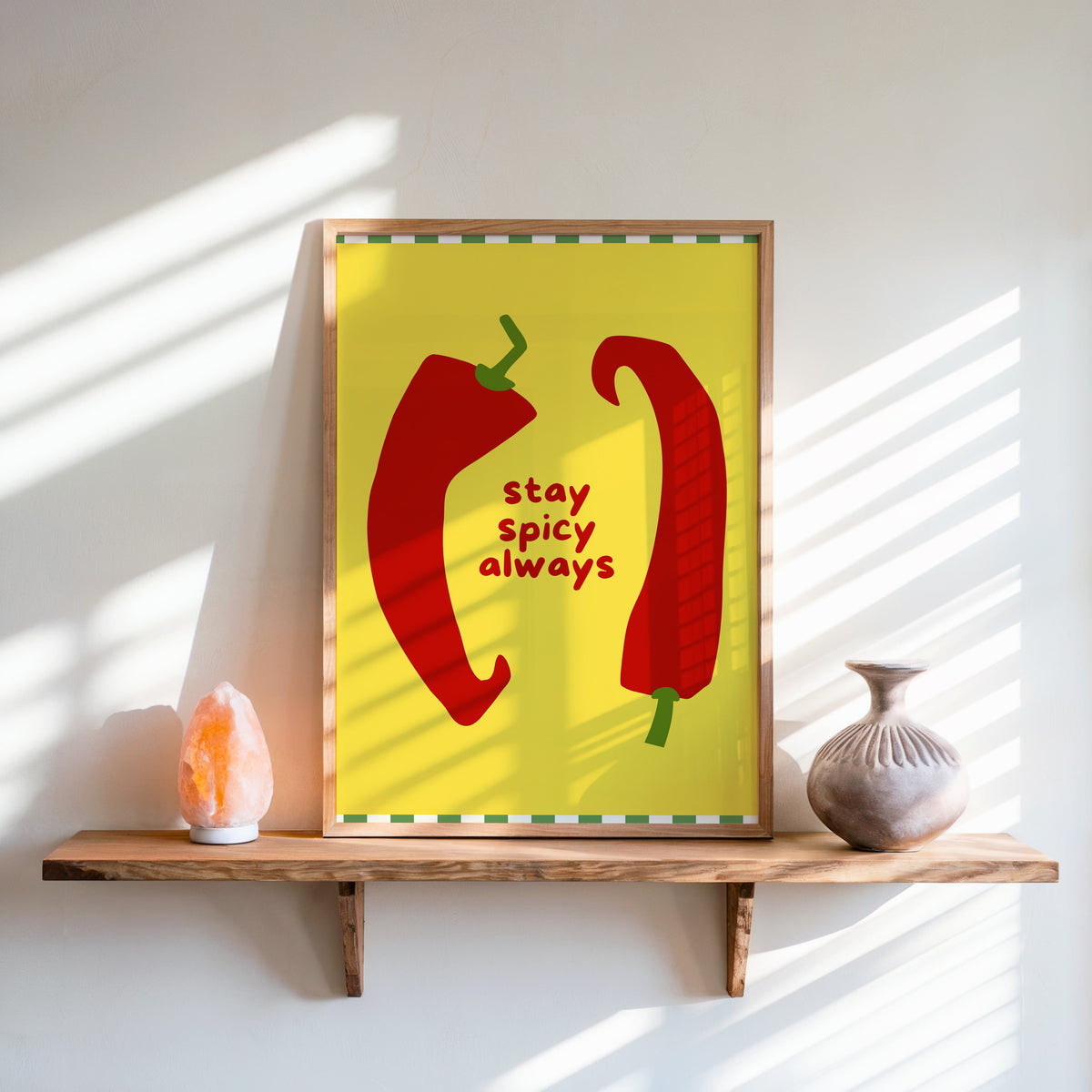 Stay Spicy Always print in an oak frame on a live-edge shelf beside a salt lamp