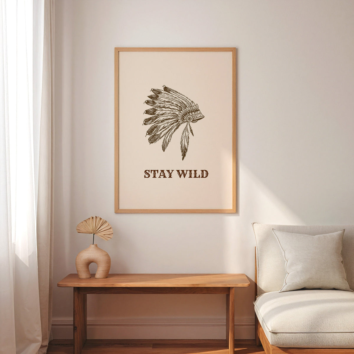 Stay Wild war bonnet cream print in an oak frame above a console with an arch vase