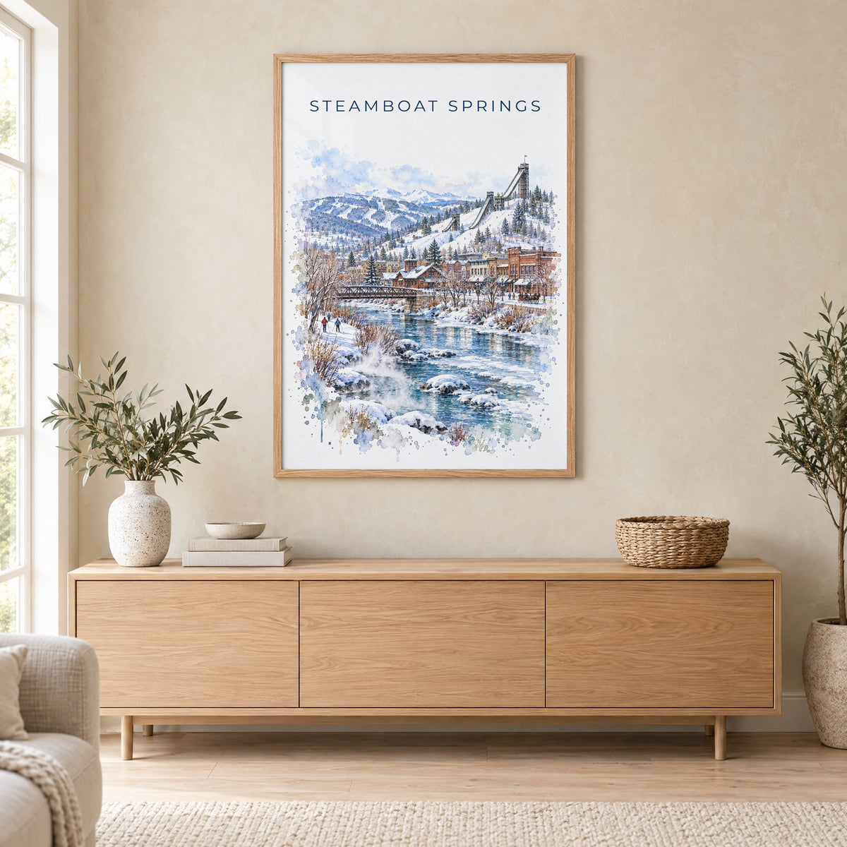 Steamboat Springs watercolor print in an oak frame above a light wood sideboard in a Scandinavian living room