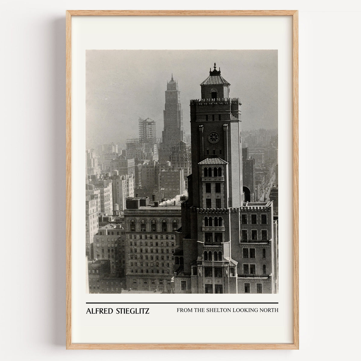 Alfred Stieglitz New York skyline print in a light oak frame on a white wall