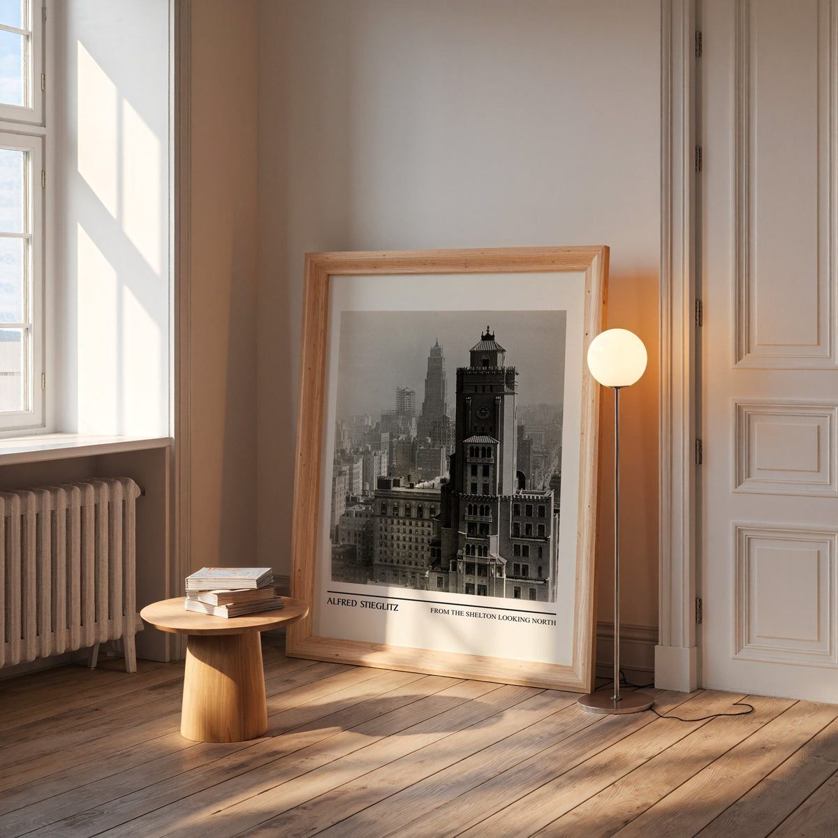 Stieglitz city print in a wide pine frame leaning by a sunlit window