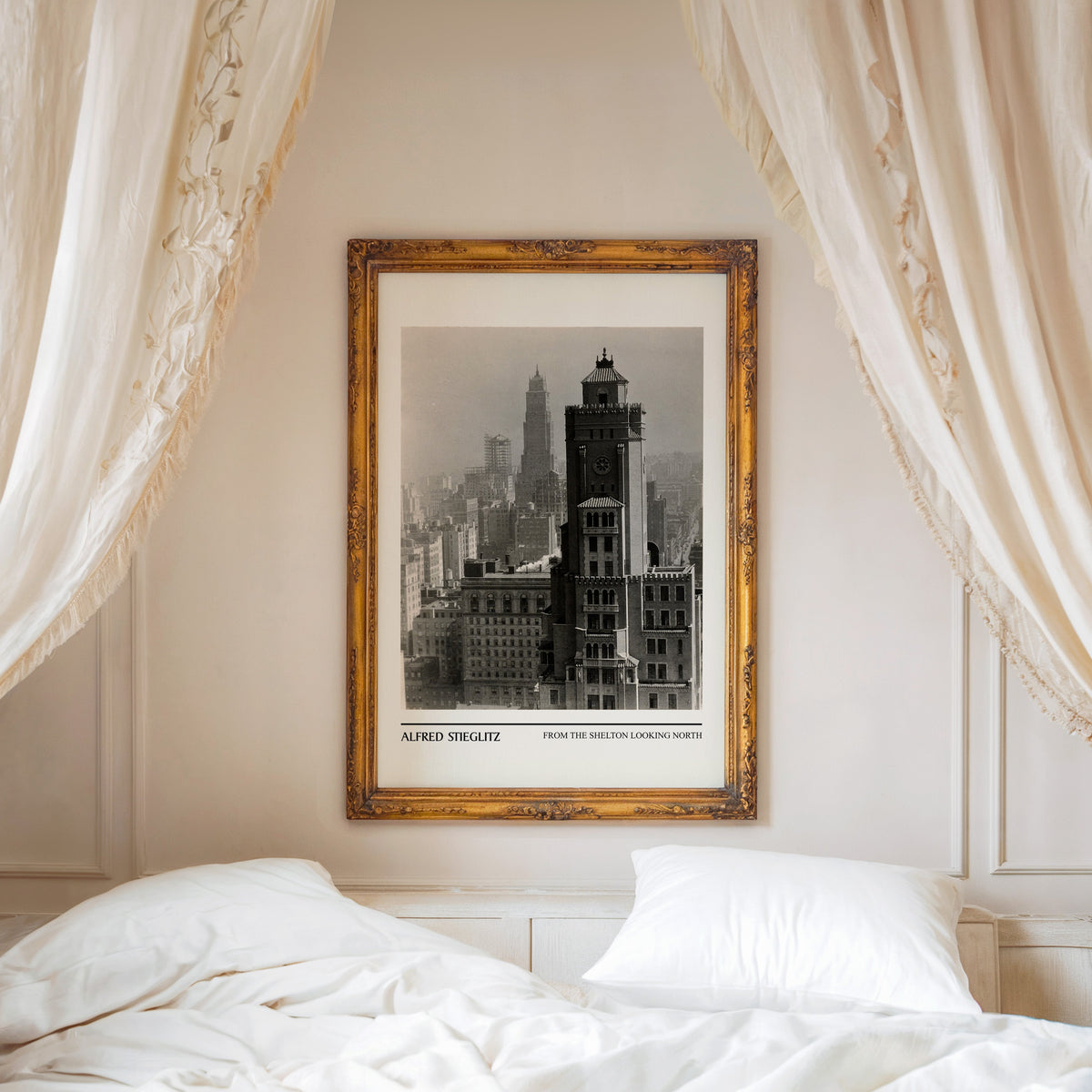 Black and white skyline print shown in an ornate gold frame above a canopy bed