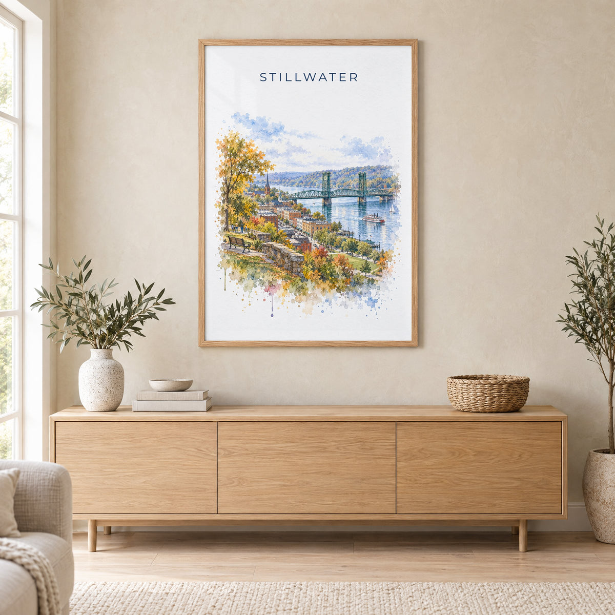 Stillwater, Minnesota watercolor print in an oak frame above a light wood sideboard in a Scandinavian living room