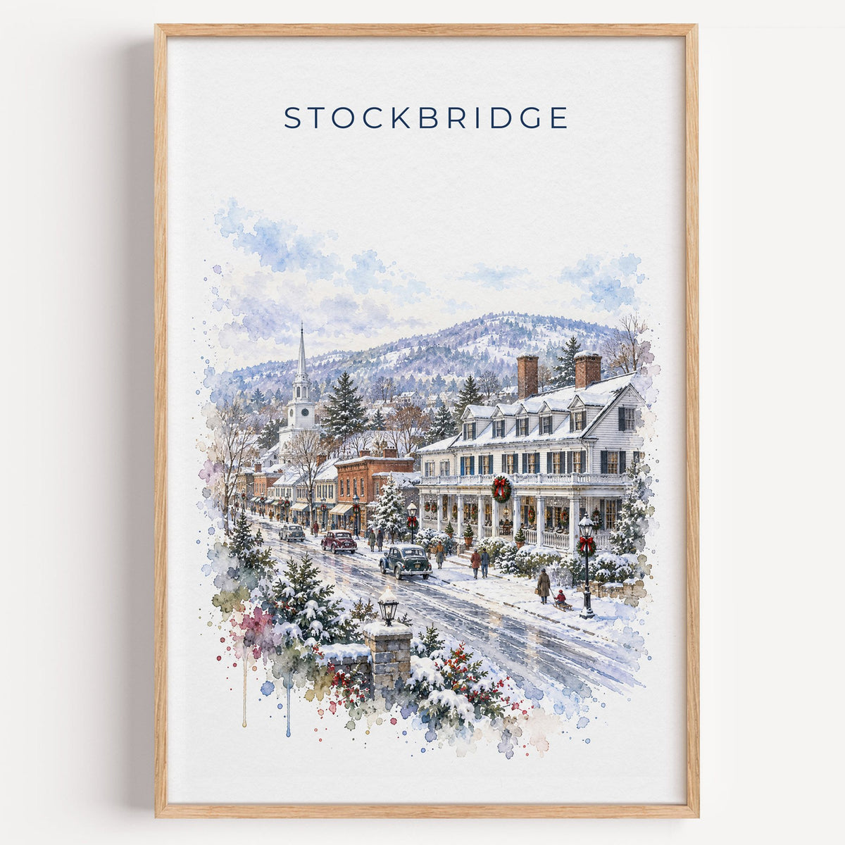 Stockbridge, Massachusetts watercolor print in a light oak frame on a plain white wall