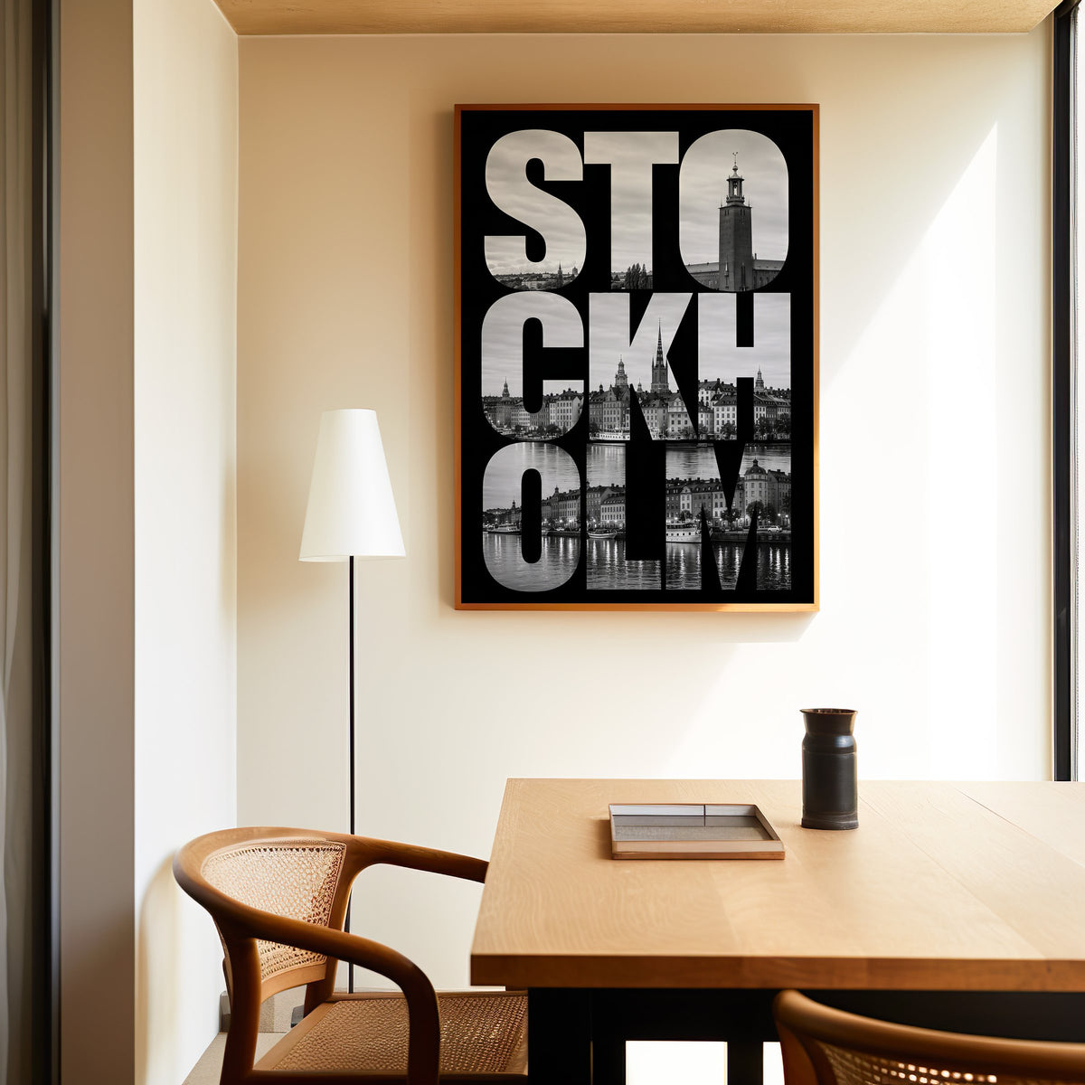 Stockholm letters filled with city photo print in an oak frame above a dining table and cane chair