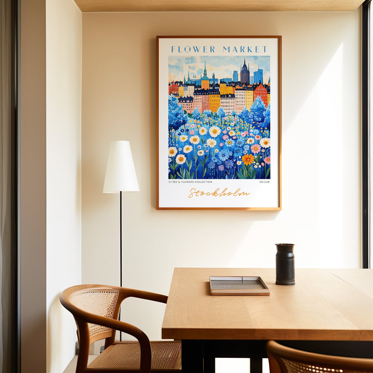Stockholm flower market print in an oak frame above a dining table and cane chair