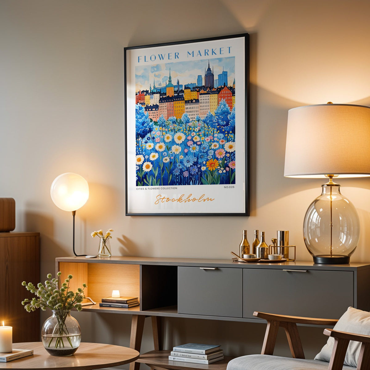 Stockholm flower market print in a black frame above a grey media console with a glass table lamp
