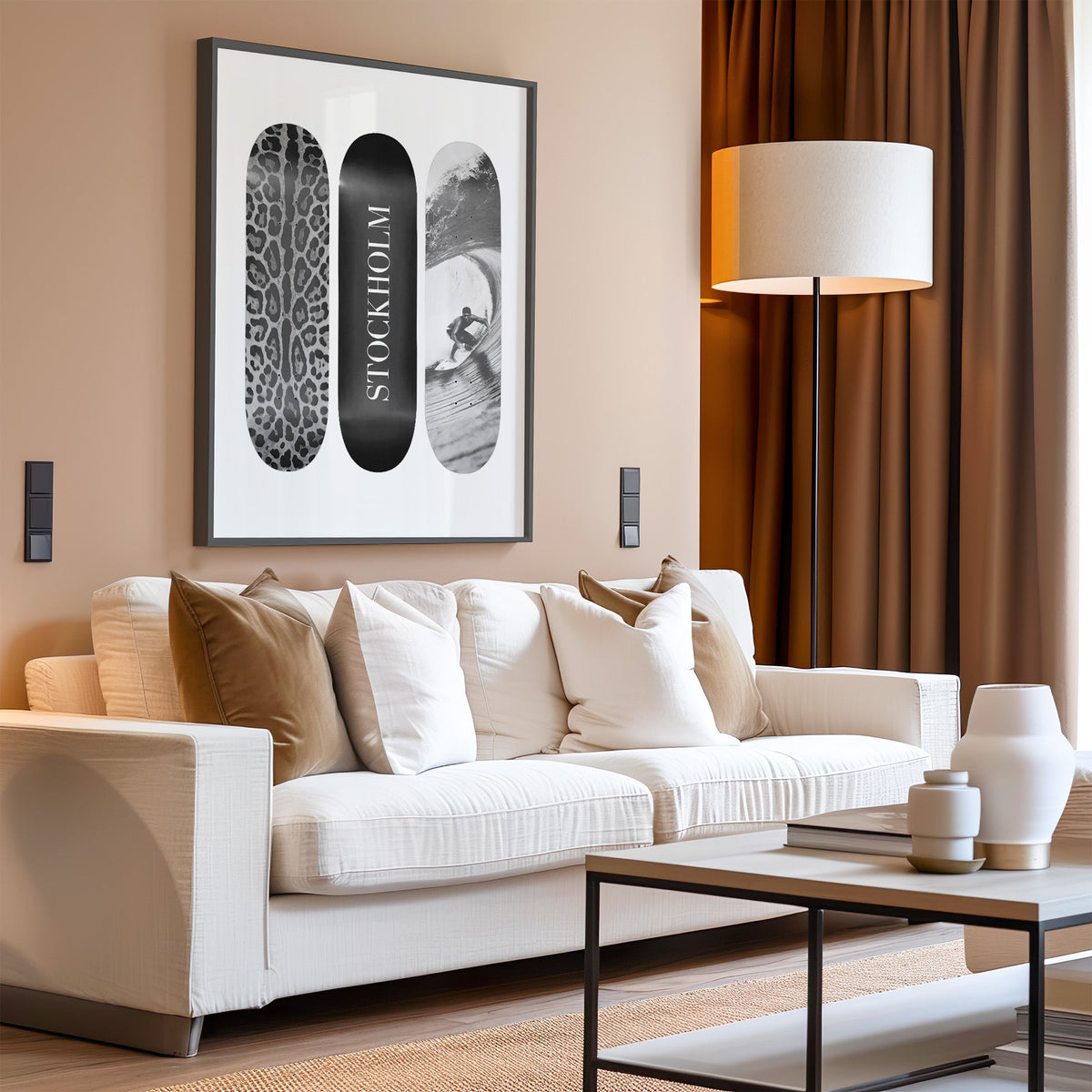 Three skateboards with leopard spots, Stockholm deck, surfer in a black frame above a cream sofa on a blush living room wall