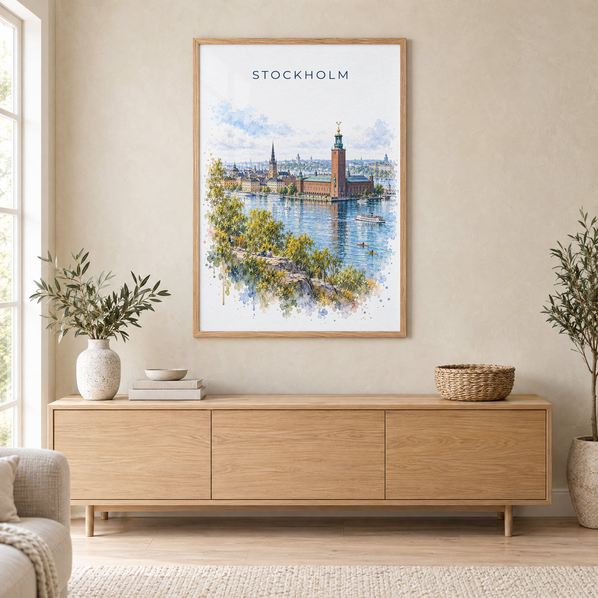 Stockholm watercolor print in an oak frame above a light wood sideboard in a Scandinavian living room