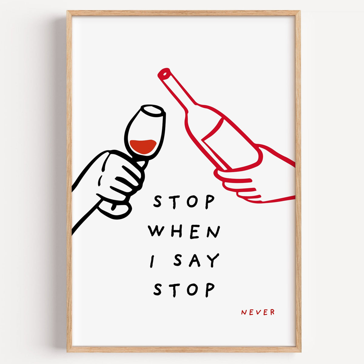 Stop When I Say Stop wine print in a light oak frame on a plain white wall