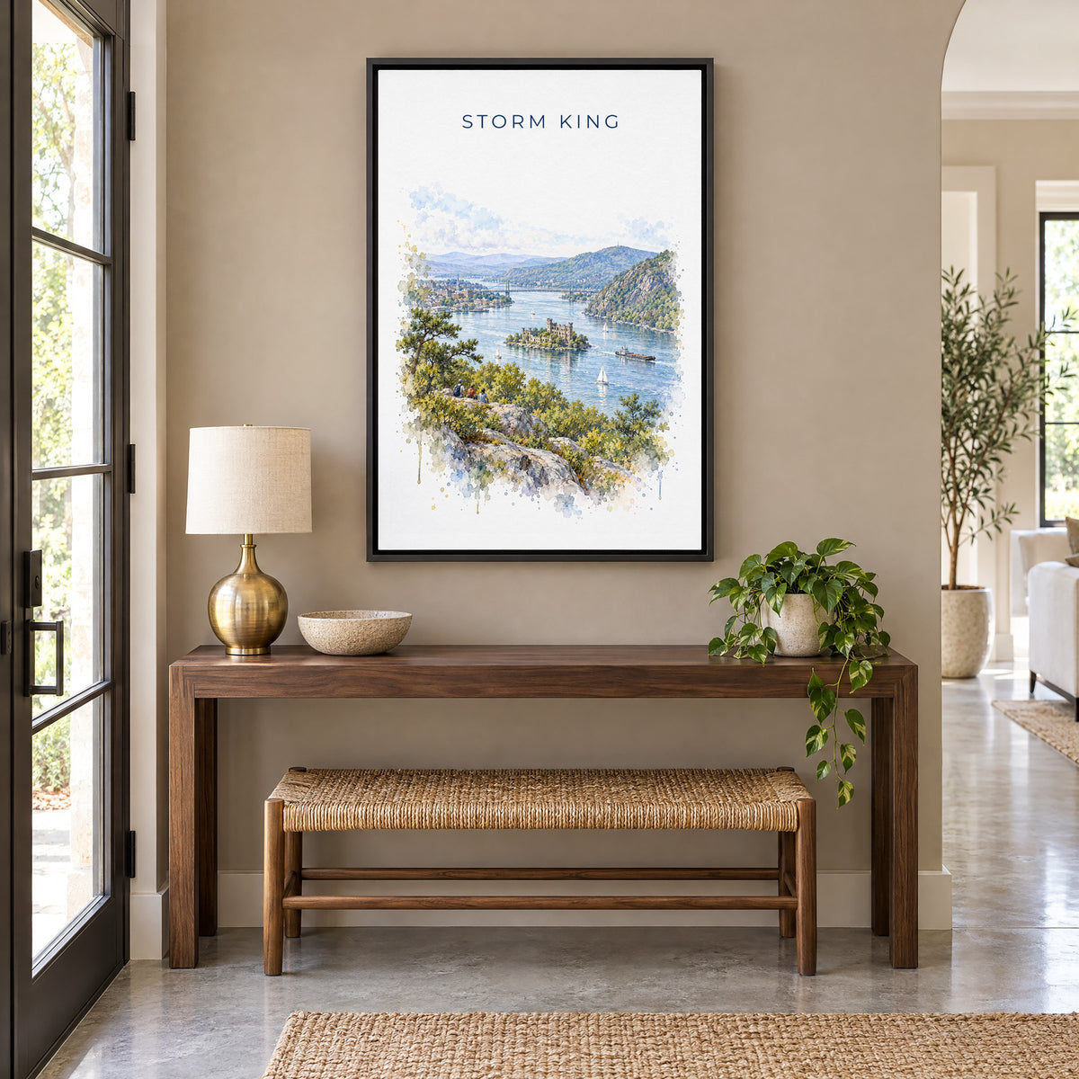 Storm King State Park watercolor print as a black floater canvas above a walnut console and woven bench in an entryway