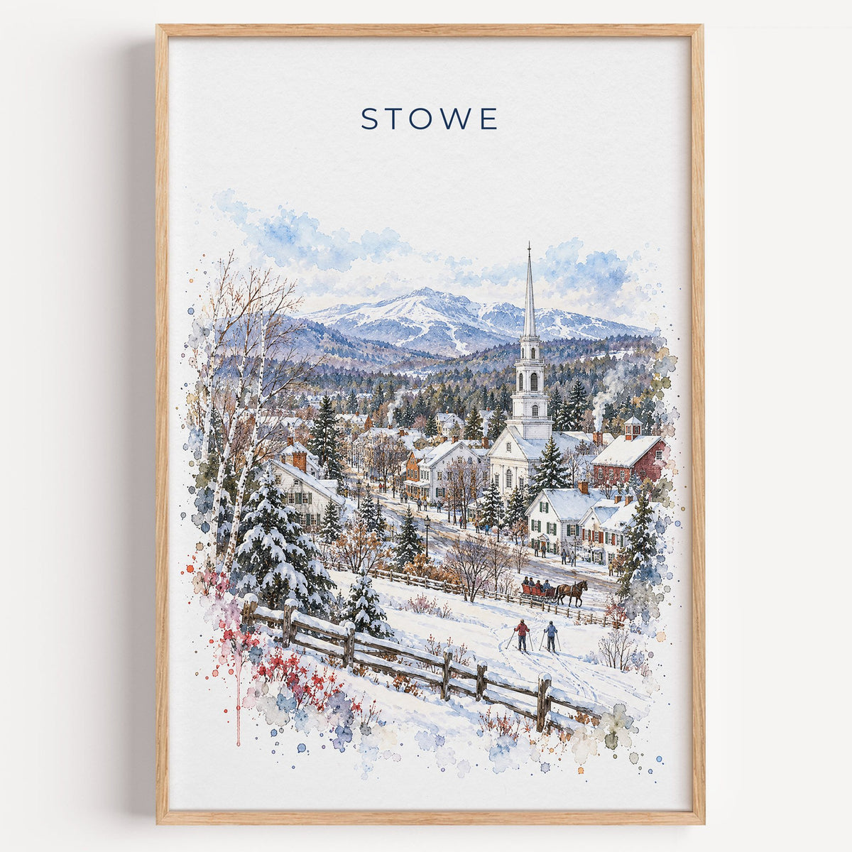 Stowe, Vermont watercolor print in a light oak frame on a plain white wall